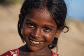 A girl on the beach of Arugam Bay.
