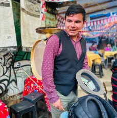 Drummer and one-man band Sebastian collects donations from guests at the excursion restaurant 'Isla de la Fantasia'.