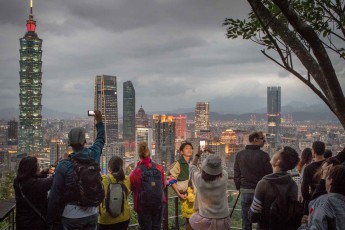 Elephant Mountain offers a comprehensive and popular view of the city, which is illuminated in the early evening.