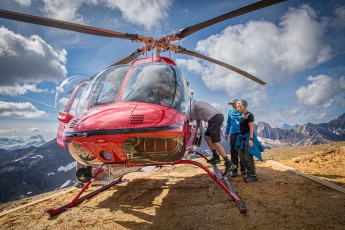 A Bell 407 helicopter on a rocky outcrop high above the Cariboo Mountains – after a two-hour hike, it’s just a few minutes’ flight back to the Cariboo Lodge.