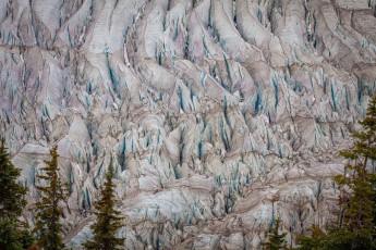Turquoise-blue cracks criss-cross the shattered ice like veins through marble – a glacier in the Cariboo Mountains is crumbling into a thousand sharp spires.