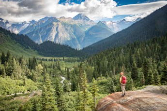 A view of the Cariboo Valley with Silver Thread Creek, spruce forests and the grey ridges of the Selkirk Range.