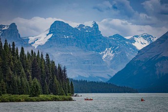 Sublime grandeur and beauty of untouched wilderness: the majestic peaks of the Canadian Rockies rise up on the horizon of Lake Maligne.