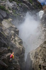 The flying fox above Zillmer Canyon as the waterfall dissolves into white mist behind him.