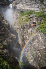 A rainbow cuts through Zillmer Canyon where spray meets wet granite. Water plunges into the gorge far below.