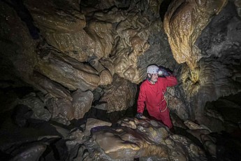 My cave buddy Bruce Marpole marvels at impressive rock formations in Rat's Nest Cave near Canmore – the bizarre structures, shaped by water, rise up like petrified waves in the darkness.