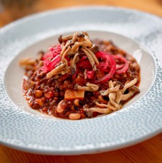 Rentierbraten unter karamellisierten Pilzen und eingelegten Zwiebeln - im Restaurant H8, dem einzigen Oqaatsuuts, treffen arktische Jagdtradition und nordische Küchenkunst aufeinander.