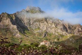 Ein einzelnes Haus unter dem Bergmassiv über Fajã.