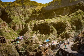 Zwei Wanderer auf dem Küstenweg von Santo Antão, gegenüber das Bergdorf Fontainhas.