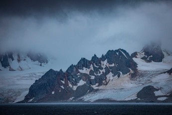 Greenwich Island – my enchanted isle. Jagged rock spires pierce the glacier mantle whilst wisps of mist veil the peaks. In this monochrome world of charcoal and white, time seems to stand still. Primeval, untouched, surreal.