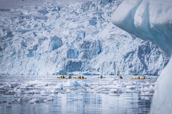Kayakers glide through the ice labyrinth of Paradise Bay.