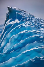Wind and water have transformed this iceberg into an abstract work of art. The wave-like grooves tell of countless melt and freeze cycles.