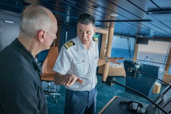 Captain Lubo explains a guest how the ship's stabilisers work.